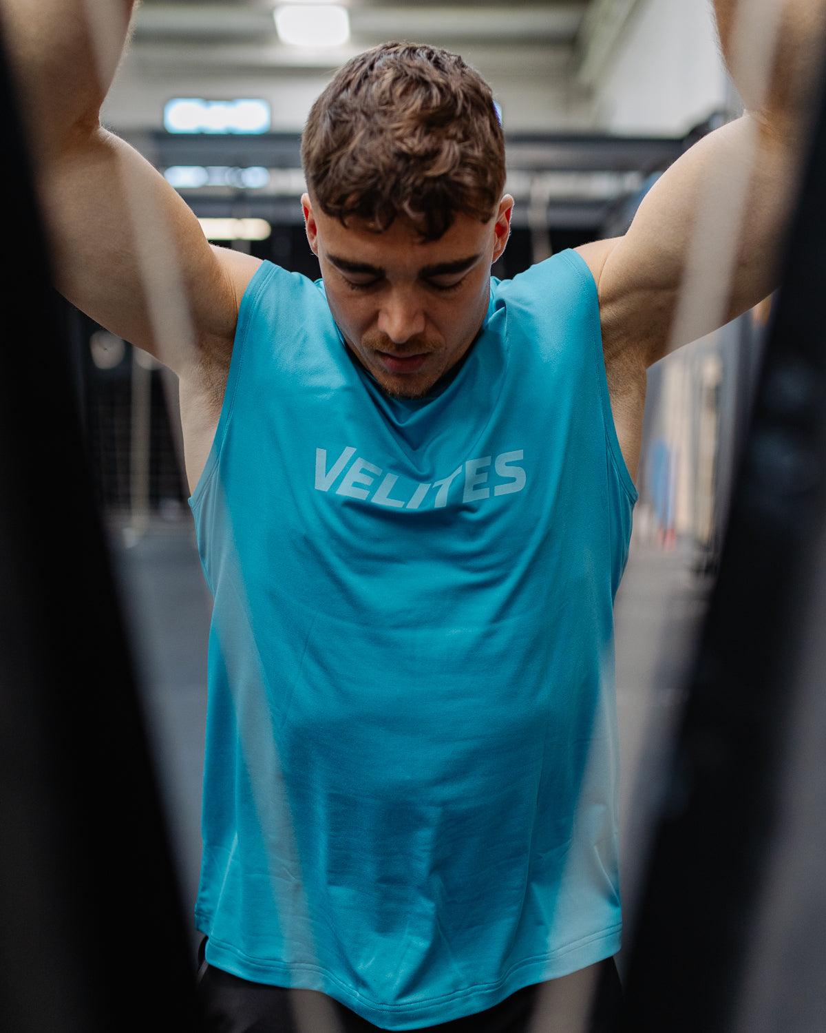 Athlete training wearing a Velites Tank Holo tank top in a box